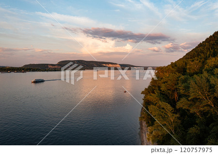 Serene dusk over the Vilga River with gentle waves and lush hills in the evening light Serene dusk over the Vilga River with gentle waves and lush hills in the evening light 120757975
