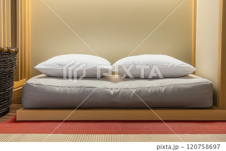 Cozy bedding setup with neutral colors in a minimalist interior design 120758697