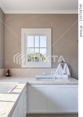 Modern bathroom interior featuring elegant design and natural light from window Modern bathroom interior featuring elegant design and natural light from window 120758740