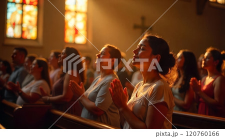 Congregants attend a worship service in a warmly lit church Congregants attend a worship service in a warmly lit church 120760166