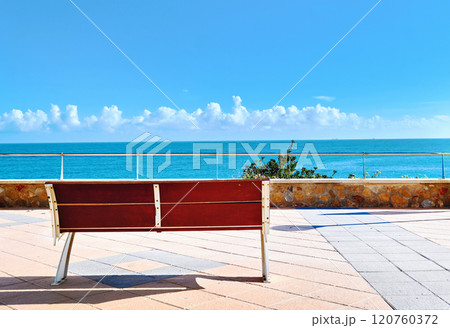 Serene view of bench overlooking blue Mediterranean Sea. Spain Serene view of bench overlooking blue Mediterranean Sea. Spain 120760372