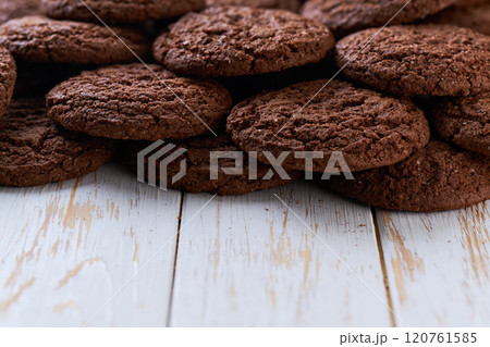 Pile of chocolate brownie cookies with cracks on a light kitchen table, selective focus. Pile of chocolate brownie cookies with cracks on a light kitchen table, selective focus. 120761585