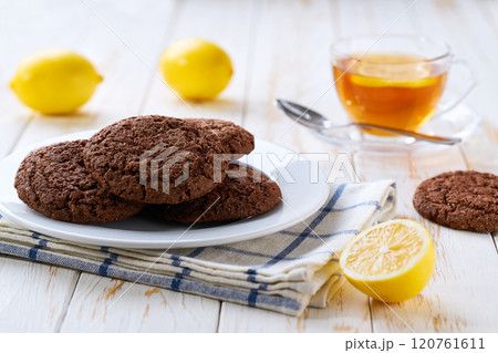 Traditional chocolate cookies and tea on a light kitchen table, selective focus. 120761611
