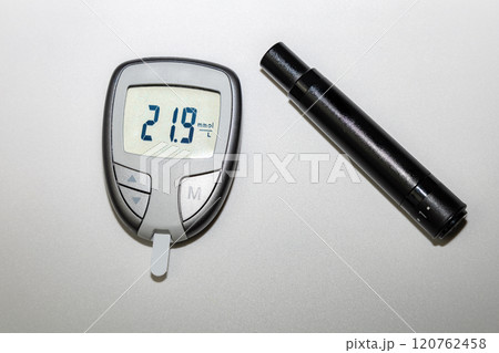 Blood sugar meter with test strips indicates high blood sugar levels. Blood sugar meter with test strips indicates high blood sugar levels. 120762458