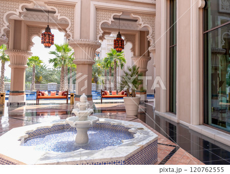 Recreation area with a fountain in an expensive hotel in Dubai. Hotel interior in middle east style. Recreation area with a fountain in an expensive hotel in Dubai. Hotel interior in middle east style. 120762555