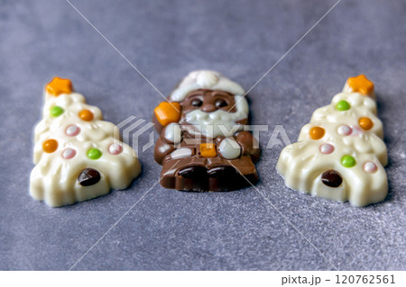 Christmas chocolates. Chocolate Christmas trees and Santa Claus. 120762561