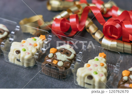 Christmas chocolates. Chocolate Christmas trees and Santa Claus. 120762670
