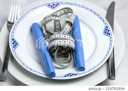 Ozempic Insulin injection pen or insulin cartridge pen for diabetics on a white plate. 120762684