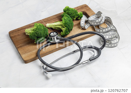 Concept of healthy eating and weight loss. Broccoli on a cutting board. Concept of healthy eating and weight loss. Broccoli on a cutting board. 120762707
