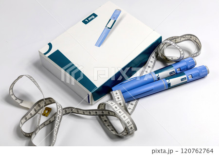 Hands in surgical gloves holding Ozempic Insulin injection pen for diabetics. Hands in surgical gloves holding Ozempic Insulin injection pen for diabetics. 120762764