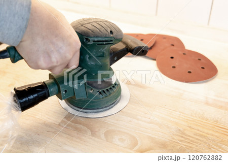 Work with a grinder on wood. Work tool. Work with a grinder on wood. Work tool. 120762882