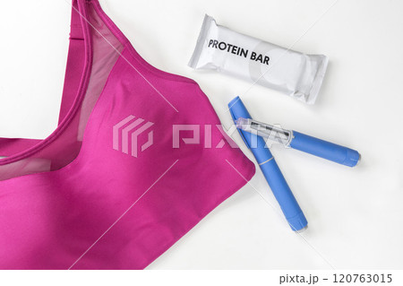 Concept of losing weight with the diabetes drug Ozempic. Sports top and Ozempic syringe pen. Concept of losing weight with the diabetes drug Ozempic. Sports top and Ozempic syringe pen. 120763015