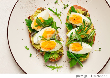 sandwich with mashed avocado, boiled egg, and arugula, on bread , homemade, breakfast, sandwich with mashed avocado, boiled egg, and arugula, on bread , homemade, breakfast, 120763542