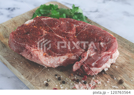 raw pork steak , pork neck, on a chopping board, marble table, top view, with spices and coriander, no people, raw pork steak , pork neck, on a chopping board, marble table, top view, with spices and coriander, no people, 120763564