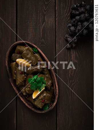 Dolma (Tolma) stuffed rolls, minced meat with rice, in grape leaves, top view, no people, close-up, 120763631