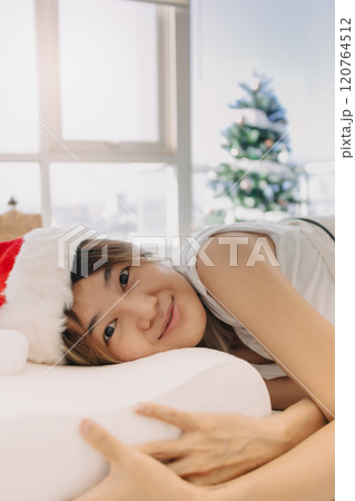 Happy woman wake up in Christmas morning expecting for a happy new year party. 120764512