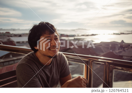 Smile man enjoy the happy moment with sunset and sea view. Smile man enjoy the happy moment with sunset and sea view. 120764521