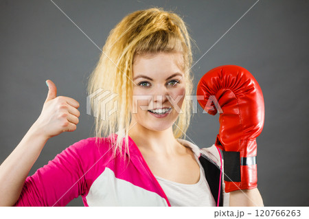 Woman wearing boxing gloves showing thumb up 120766263