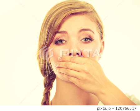 Sad woman covering mouth with hand 120766317