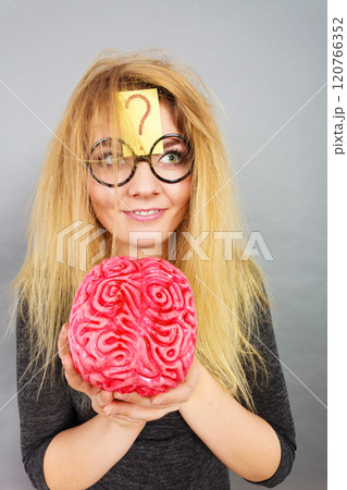 Weird woman holding brain having idea 120766352