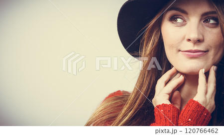 pretty girl with brown hair and black hat. 120766462
