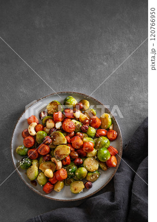 Cabbage with sausages, nuts and sesame. Concept of nutritious dish in plate  120766950
