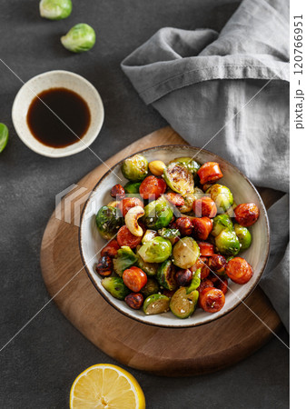 Cabbage with sausages, nuts and sesame. Concept of nutritious dish in a bowl 120766951
