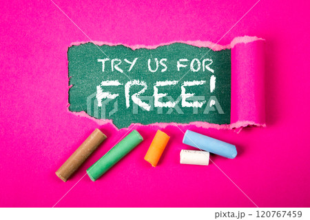 Try Us For Free. Text under torn purple paper on a green chalkboard Try Us For Free. Text under torn purple paper on a green chalkboard 120767459