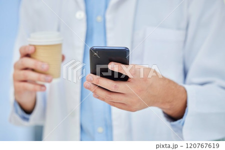 Doctor, coffee break and cup, smartphone technology and mobile app, reading notification and connection in hospital. Healthcare worker hands, drinking coffee and using phone, telehealth and contact Doctor, coffee break and cup, smartphone technology and mobile app, reading notification and connection in hospital. Healthcare worker hands, drinking coffee and using phone, telehealth and contact 120767619