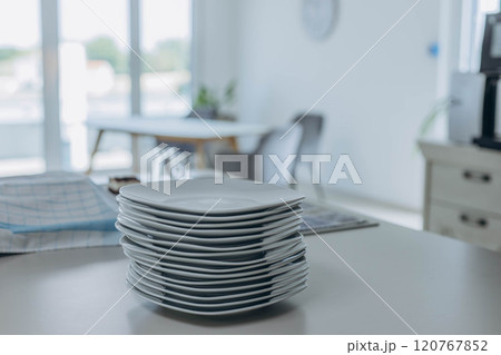 Stack of white plates prepared for serving, clean and ready for table setting. Stack of white plates prepared for serving, clean and ready for table setting. 120767852