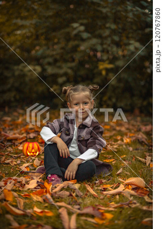 little girl smiles in a Halloween in Park in autumn 120767860