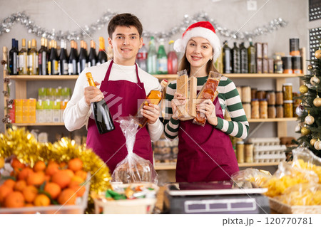 Woman and man sellers offering alcohol and sweets Woman and man sellers offering alcohol and sweets 120770781