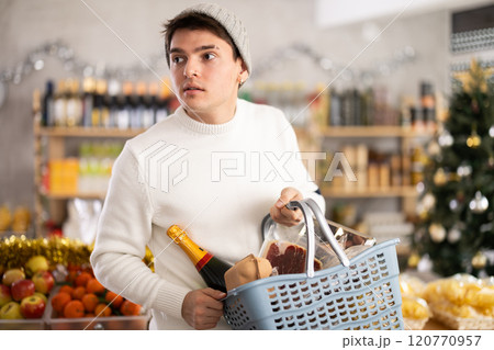 Visiting store on New Years Eve, guy is looking at something on shelf of showcase. 120770957