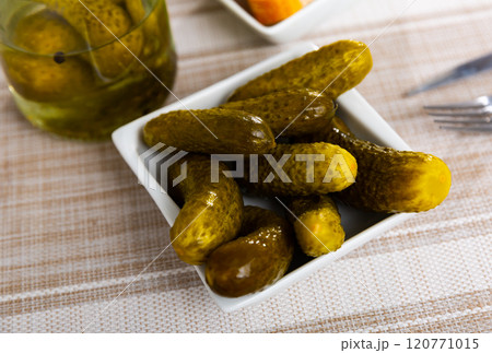 Pickled cucumbers on a ceramic plate 120771015