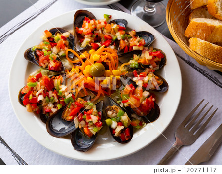 Delicious mussels served with vinaigrette from vegetables Delicious mussels served with vinaigrette from vegetables 120771117