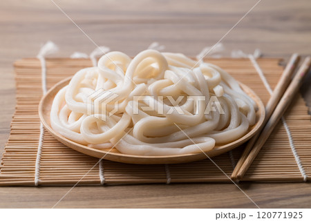 Udon noodles on wooden plate with chopsticks, Thick noodles in Japanese cuisine 120771925