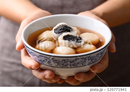Tangyuan (Chinese sweet dumpling), Glutinous rice flour filling with black sesame in ginger syrup 120771941
