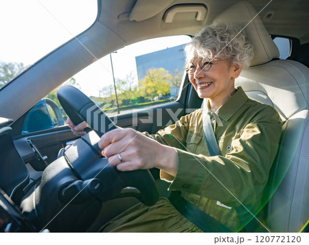 笑顔で自動車を運転するシニア女性 120772120