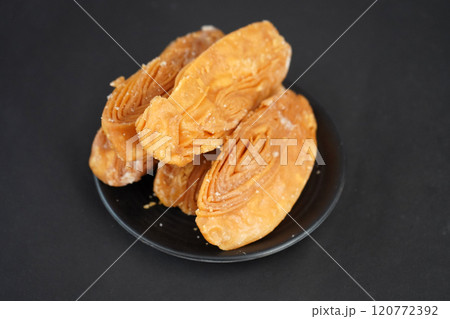 Crunchy khaja in black plate Crunchy khaja in black plate 120772392