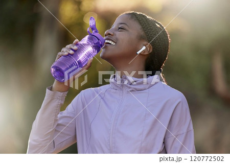 Exercise, black woman and drinking water for fitness, wellness and health outdoor to relax. Sports, young female Nigerian and athlete hydration, liquid for break and training for workout and earbuds. Exercise, black woman and drinking water for fitness, wellness and health outdoor to relax. Sports, young female Nigerian and athlete hydration, liquid for break and training for workout and earbuds. 120772502
