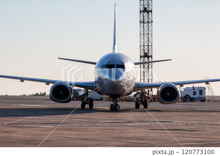 Front view taxiing airplane on the airport apron Front view taxiing airplane on the airport apron 120773100
