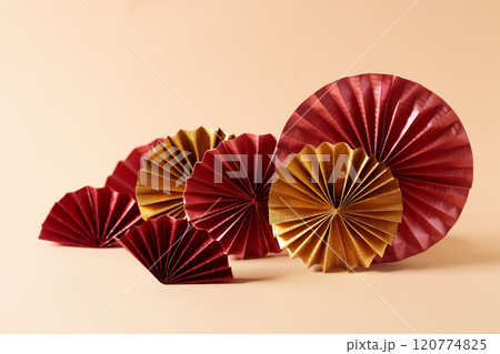 Chinese new year festival decorations with red Chinese folded fans on soft orange color background. 120774825