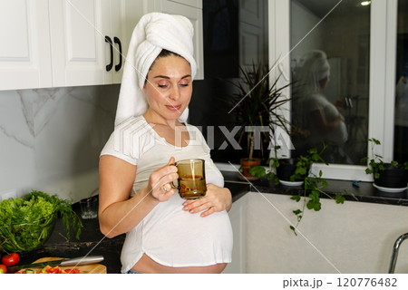 Pregnant Woman Enjoying Tea in the Kitchen Pregnant Woman Enjoying Tea in the Kitchen 120776482
