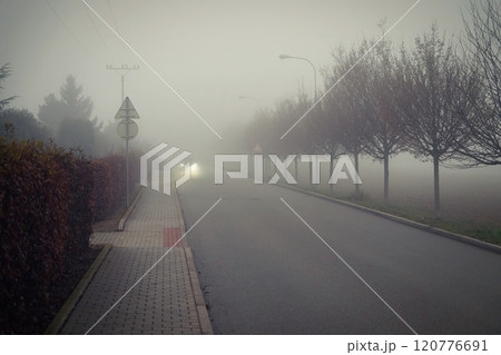 Bad weather driving - foggy hazy country road. Motorway - road traffic. Winter time. Bad weather driving - foggy hazy country road. Motorway - road traffic. Winter time. 120776691