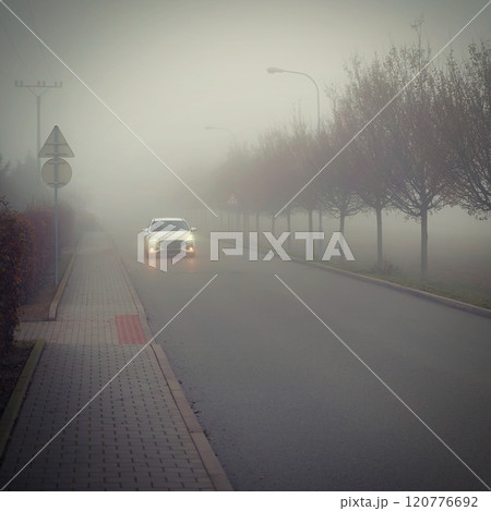 Bad weather driving - foggy hazy country road. Motorway - road traffic. Winter time. 120776692