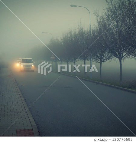 Bad weather driving - foggy hazy country road. Motorway - road traffic. Winter time. Bad weather driving - foggy hazy country road. Motorway - road traffic. Winter time. 120776693