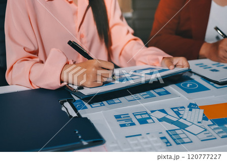 Young Asian business creative team work together, mobile application software design project. Brainstorm meeting, internet technology, smartphone web app designer, office coworker teamwork concept Young Asian business creative team work together, mobile application software design project. Brainstorm meeting, internet technology, smartphone web app designer, office coworker teamwork concept 120777227