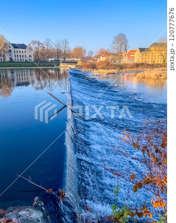Scenic small river dam with historic buildings under a clear blue sky. High quality photo Scenic small river dam with historic buildings under a clear blue sky. High quality photo 120777676