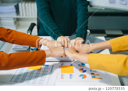 Close up on hands of business people join together their hands together on unity concept 120778535