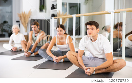 Group of different people doing exercises in gym Group of different people doing exercises in gym 120778720
